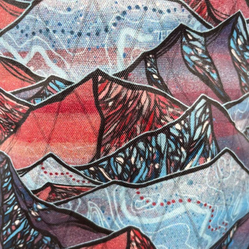 Close-up of Oveja Negra's Sangre de Vida fabric pattern, featuring bold, vibrant colors and intricate designs inspired by adventure and exploration.